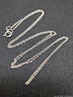 Full view of the 16-inch white gold chain on a black background, showing the entire chain and clasp.