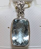 Front view of the 14K gold pendant with a rectangular cushion-cut aquamarine gemstone showing the stone's clarity and facets.
