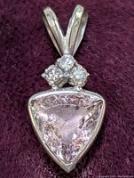 Close-up front view of the 14K gold pendant showing the triangular pink tourmaline and diamond cluster.