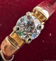 Close-up view of the prong-set round diamond and part of the band