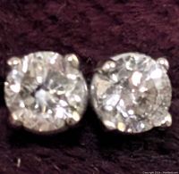Close-up view of both round brilliant diamonds in four-prong settings