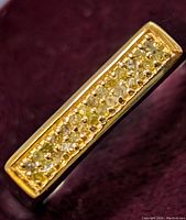 Close-up image of the rectangular diamond cluster setting in the sterling silver ring.