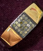 Close-up of rectangular diamond cluster top on wide sterling silver band showing different angles.