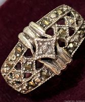 Close-up of sterling silver marcasite ring showing the detailed lattice openwork and marcasite stones with a central square marcasite cluster and decorative silver frame.