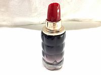 Bottle of Cacharel Yes I Am Cacharel perfume eau de parfum 50 ml, shaped like a lipstick with a red cap shown from front and slightly angled views.