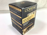 Front and angled side view of black and gold box packaging for L'Oreal Age Perfect Cell Renewal Midnight Cream with product claims and 50ml size.