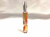 Front view of Michel Germain Sugarful & Spice 0.27 oz Eau de Parfum rollerball bottle with orange and yellow swirling design and silver cap.