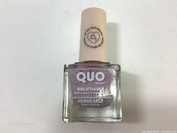 Bottle of nail polish showing front label with brand, product line, and volume.