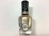 Front view of Sally Hansen Miracle Gel nail polish bottle showing gold metallic color and label