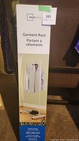 Photo of the unopened Mainstays garment rack box with front view showing product image and brand name.