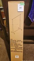 Photo of the unopened cardboard box showing illustration of garment rack, size, and product details.