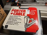 Photo of the original red and white product box with brand and model number