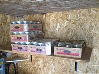 Five cases of Golden Harvest mason jars stacked on a wood shelf, showing four shrink-wrapped unopened and one open case.