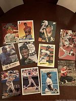 Photo of 11 loose baseball cards spread on a table, featuring different MLB players from various brands.