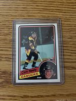 Front image of Cam Neely rookie hockey card in protective sleeve, showing player in Vancouver Canucks kit.