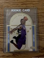 Front view of the Chris Bosh rookie card in Toronto Raptors purple uniform, mid-air with basketball.