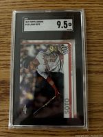 Front of Juan Soto 2019 Topps Chrome graded rookie card showing player batting in Nationals uniform with SGC 9.5 grade label.