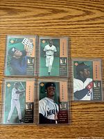Nine Ken Griffey Jr baseball cards all numbered and sleeved, showing various poses and Mariners uniforms with green background and brown side bars with Upper Deck logo