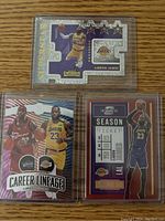 Three rare LeBron James basketball cards: Contenders Optic season ticket, Career Lineage, and Contenders Superstar die cut.