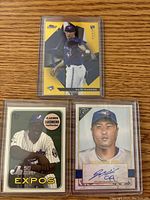 Photo showing three MLB baseball cards: Nate Pearson Topps Finest Gold 11/50, Vladimir Guerrero Montreal Expos 50th Anniversary, and Hyun-Jin Ryu autograph Blue Parallel Prizm 18/50.