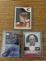 Lot includes 3 hockey defenseman cards: Al MacInnis rookie, Chris Chelios memorabilia, Colton Parayko autograph numbered card.