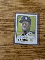 Front of the Ronald Acuna Jr rookie card in protective plastic holder showing the stylized portrait, name, and team.