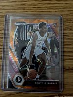 Front of the 2021 Prizm rookie card showing Scottie Barnes in Florida State uniform with orange cracked ice design and RC logo.
