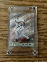 Front of the Cal Ripken Jr. card in a protective case showing him batting with a foil background effect and embossed text.