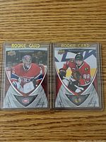 Two rookie hockey cards displayed side by side in protective sleeves, Carey Price on the left, Patrick Kane on the right.