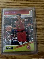 Front of rookie card showing Trae Young in Atlanta Hawks uniform, Pink Prizm, Playoff edition with RC logo.