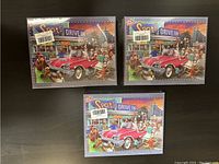 Front view of three sealed identical boxed puzzles showing colorful drive-in scene with dogs and red car on the cover titled 'Spot's Drive In'