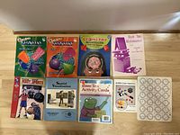 Top view of the full set of educational resource books and activity cards, showing colorful covers and titles related to geometry, math, and spatial skills.