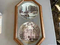 Front view of the oak frame containing two decorative plates depicting Belleville Harbour and Glanmore House.