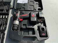 Photo showing Jobmate cordless drill, battery, charger, and case