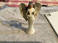 Standing angel figurine with wings and inscription