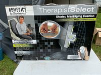 Front view of original boxed HoMedics Therapist Select Shiatsu Massaging Cushion showing brand, model, features like moving Shiatsu massage mechanism and programmable remote.