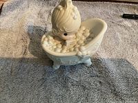 Child in bathtub figurine with 'He Cleansed My Soul' marking underneath
