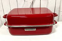 Red enamel KitchenAid double roaster with lid closed, showing glossy finish and handles