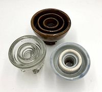 Top view showing the three insulators with different colors and materials: brown ceramic, blue ceramic, and clear glass.