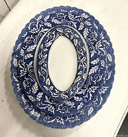 Set of three nested oval platters showing the blue and white floral Lucerne pattern with scalloped edges.