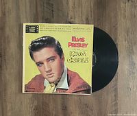 Photo showing the Elvis Presley King Creole LP vinyl record partly out of its album cover, featuring a close-up of the cover art and label.