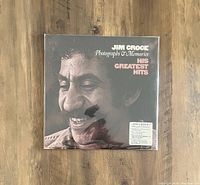 Front cover of Jim Croce vinyl LP 'Photographs & Memories: His Greatest Hits' showing the artist's smiling face in close-up and album title.