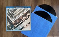 Photo showing the gatefold album cover of The Beatles 1967-1970 with two vinyl records and blue inner sleeves.