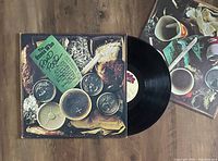 View of The Guess Who Road Food album cover and partially visible vinyl record with label.