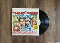 Front cover of The Mamas & The Papas 20 Greatest Hits LP vinyl record showing the band photo and track listings on cover.