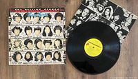 Complete view of the Some Girls vinyl record next to the original album sleeve showing the partially obscured celebrity faces artwork.