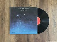 Photo displaying the front of the Willie Nelson Stardust vinyl LP cover partially open with the record visible.
