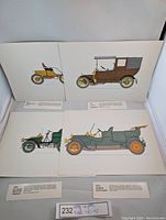 Four original 1960s Rousell lithograph prints of antique vehicles displayed side by side showing detailed colored illustrations.