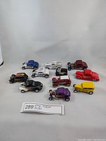 Overview of all 11 diecast roadster cars positioned on white background showing variety of colors and styles