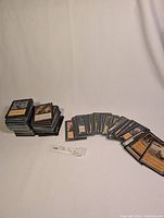 Two stacks of MTG cards and a fanned row of loose cards on white background
